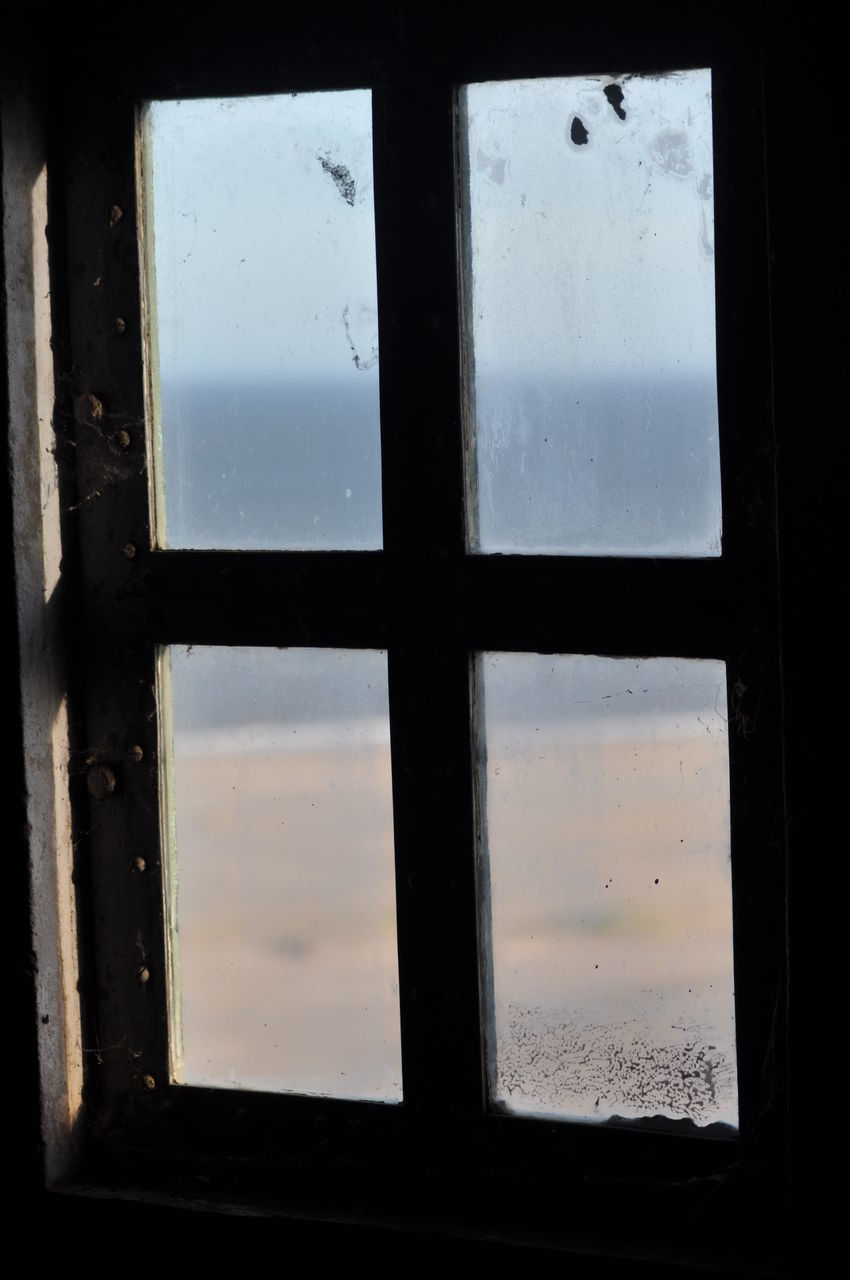 CLOSE-UP OF WINDOW IN OLD GLASS