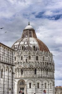 Low angle view of building against cloudy sky