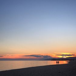 Scenic view of sea against clear sky during sunset