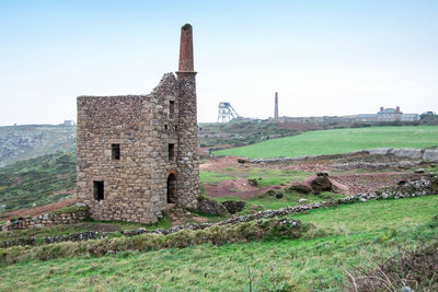 Old ruin building on field against clear sky