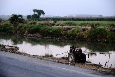 Scenic view of road by land against sky