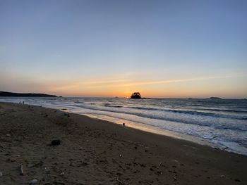 Scenic view of beach against sky during sunset