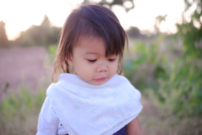 Portrait of cute girl standing on field