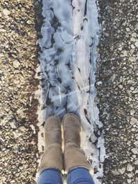 Low section of woman standing on ground