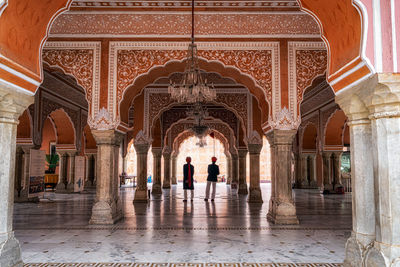 People walking in historic building