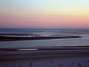 Scenic view of beach against sky during sunset