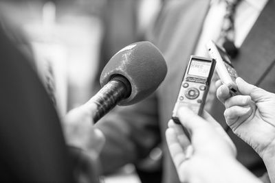 Digital voice recorder and microphone in focus, news or press conference or media interview