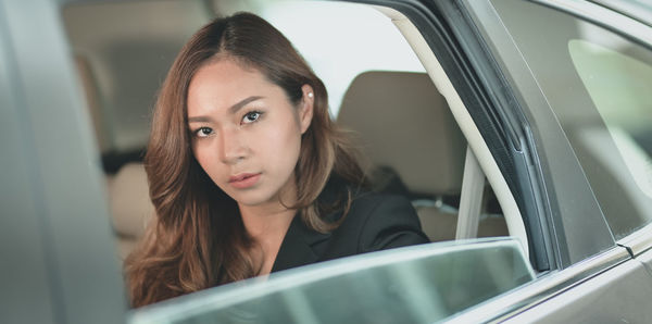 Portrait of woman sitting in car