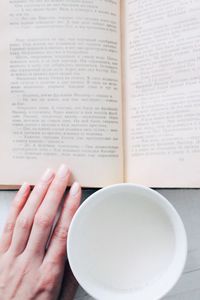 Close-up of woman hand in plate