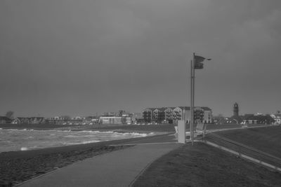 Road by sea against sky in city