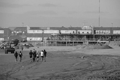 People at beach against sky