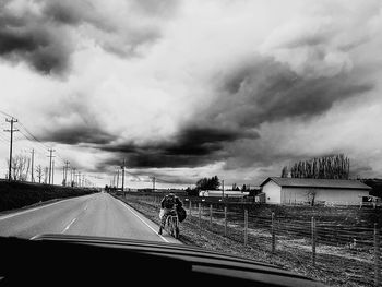 Storm clouds over bridge against sky