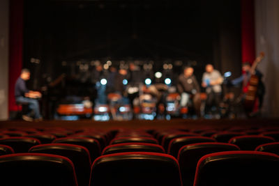 Men on stage in auditorium