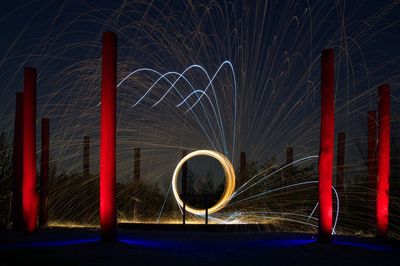 Close-up of illuminated text against sky at night