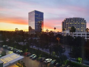 Buildings in city against sky during sunset