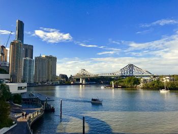 Bridge over river with buildings in background