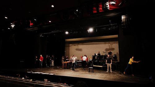 People standing in illuminated room