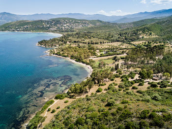 High angle view of land and sea against sky