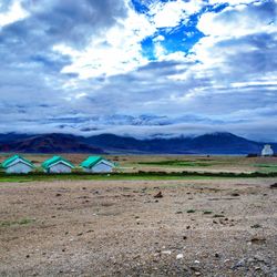 Scenic view of landscape against cloudy sky