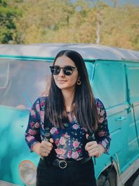 Young woman wearing sunglasses standing outdoors