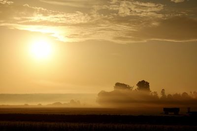 Scenic view of field against sky during sunset