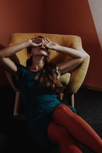 Woman leaning on armchair