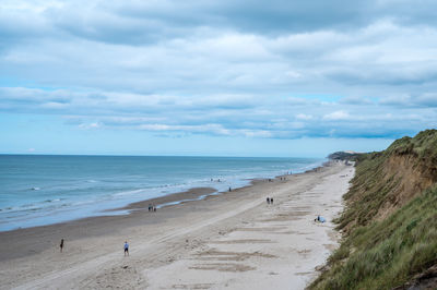 Beach north of løkken, rubjerg knude lighthouse in horizon