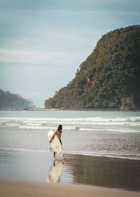 Full length of man on beach against sky