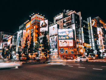 Illuminated city street and buildings at night