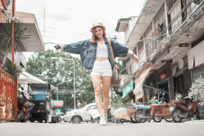 Portrait of smiling young woman in city