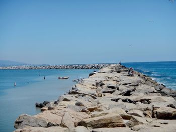 Scenic view of sea against clear blue sky