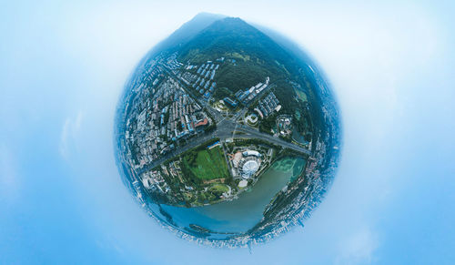 Digital composite image of buildings against sky