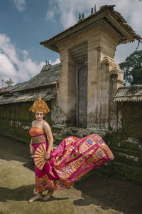 Woman wearing traditional clothing standing on road