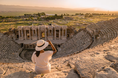 Rear view of woman at old ruins