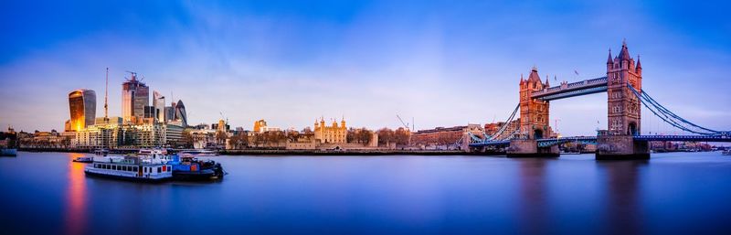 Tower bridge over river with buildings in background