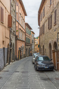 Cars on street amidst buildings in city