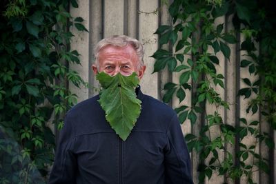 Portrait of woman standing by plants