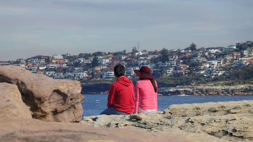 Rear view of man and woman looking at view