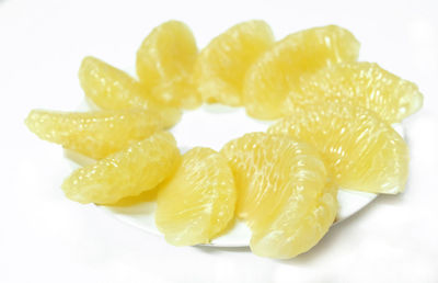 Directly above shot of lemon slice against white background