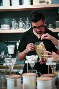 Midsection of man preparing food in kitchen