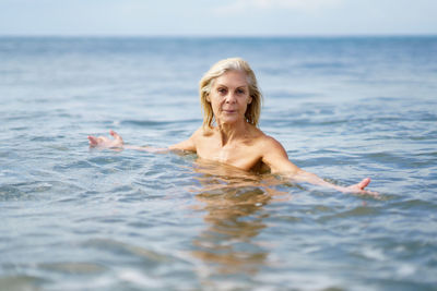 Senior woman bathing in sea