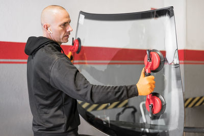 Side view of man working in bus