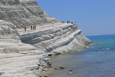 Low angle view of people on beach