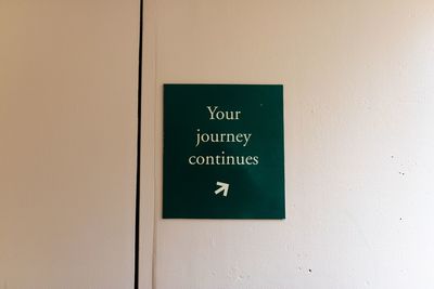 Close-up of information sign on wall