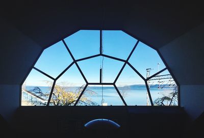 View of blue sky seen through window