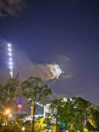 Low angle view of illuminated buildings against sky at night