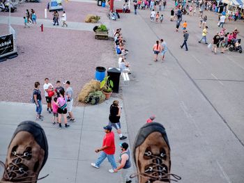 Low section of man against people walking on street during nebraska state fair