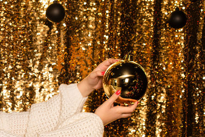Midsection of woman holding christmas decoration