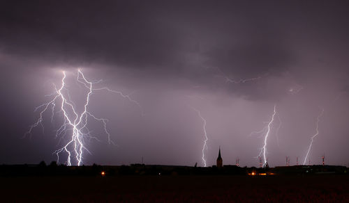 Low angle view of lightning in sky at night