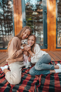 Mother and daughter sitting outdoors